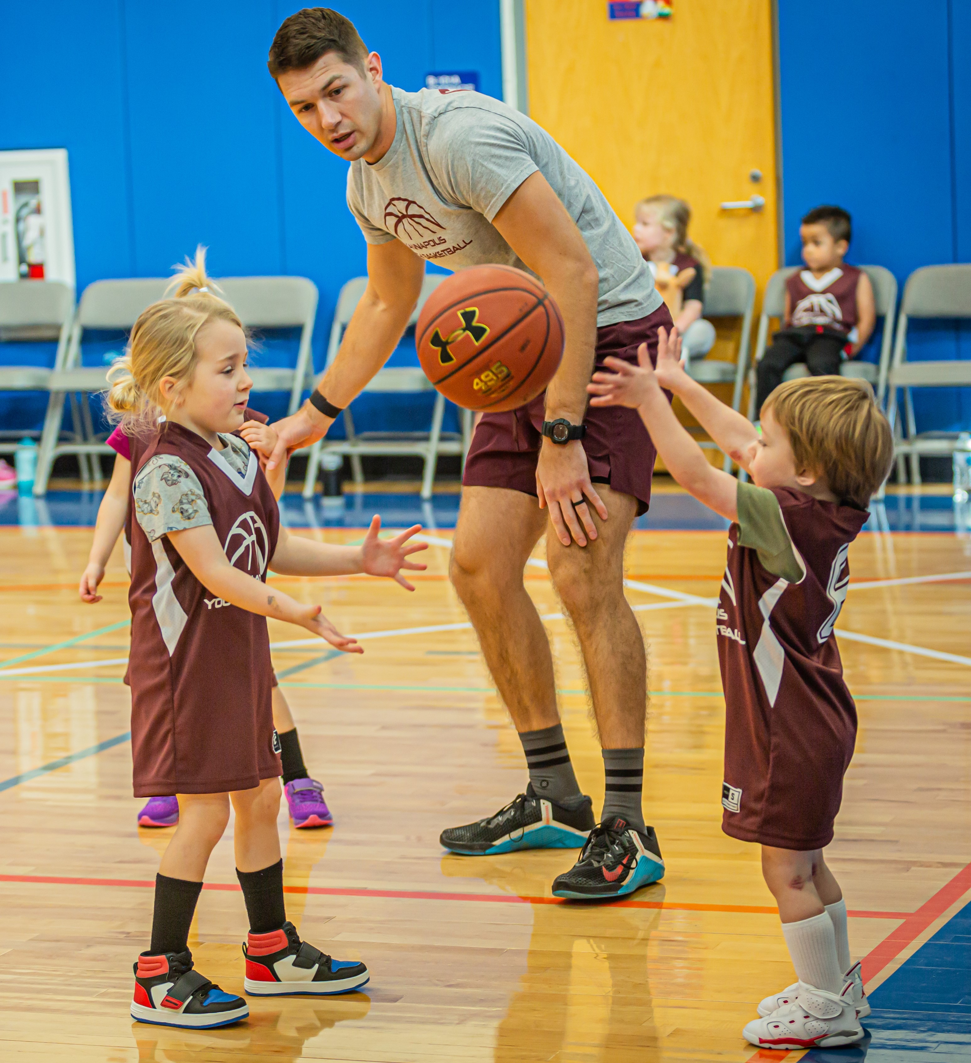coach instructing young basketball players