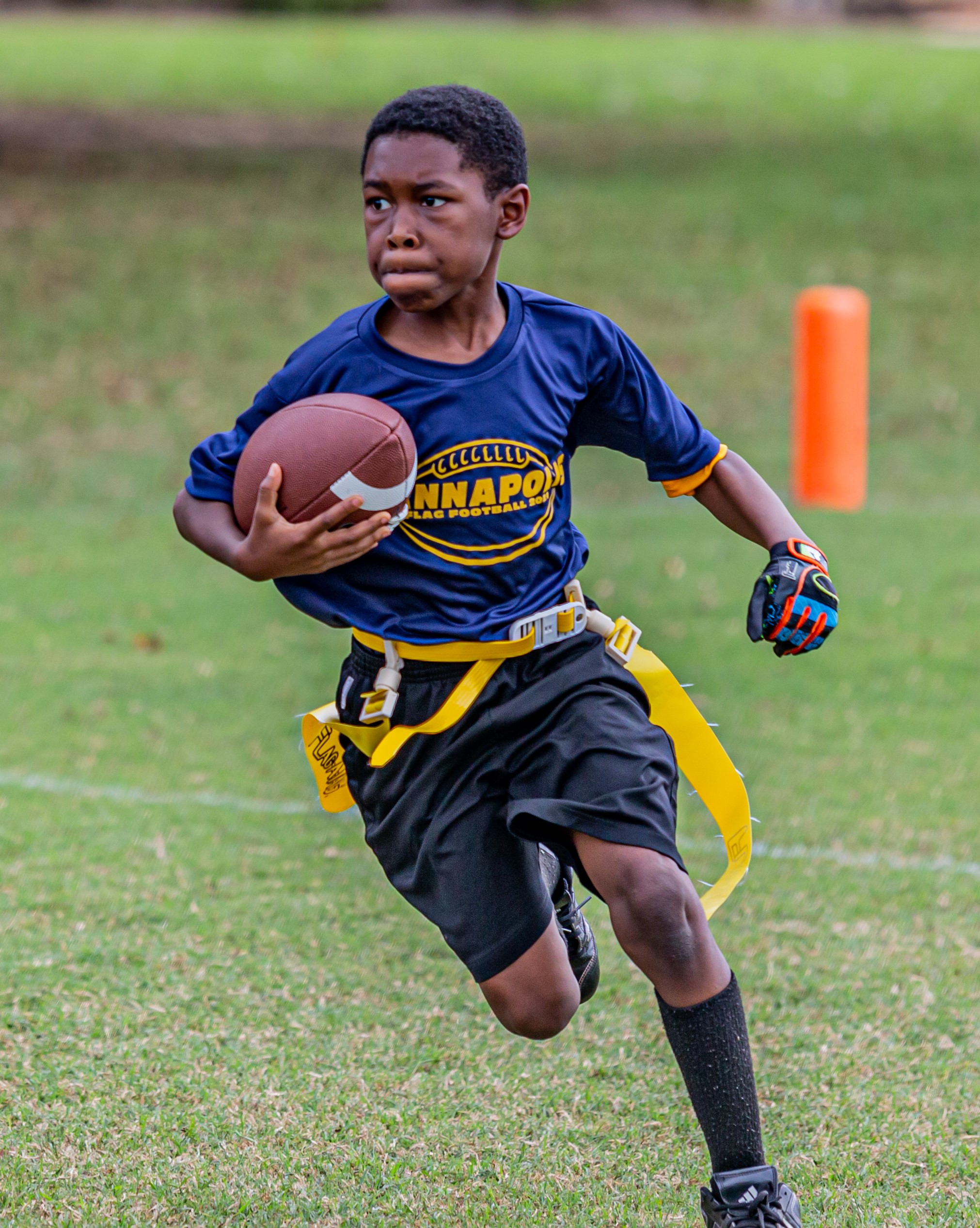 flag football player running with football