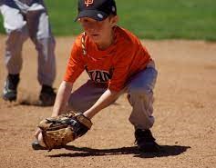 boy fielding baseball