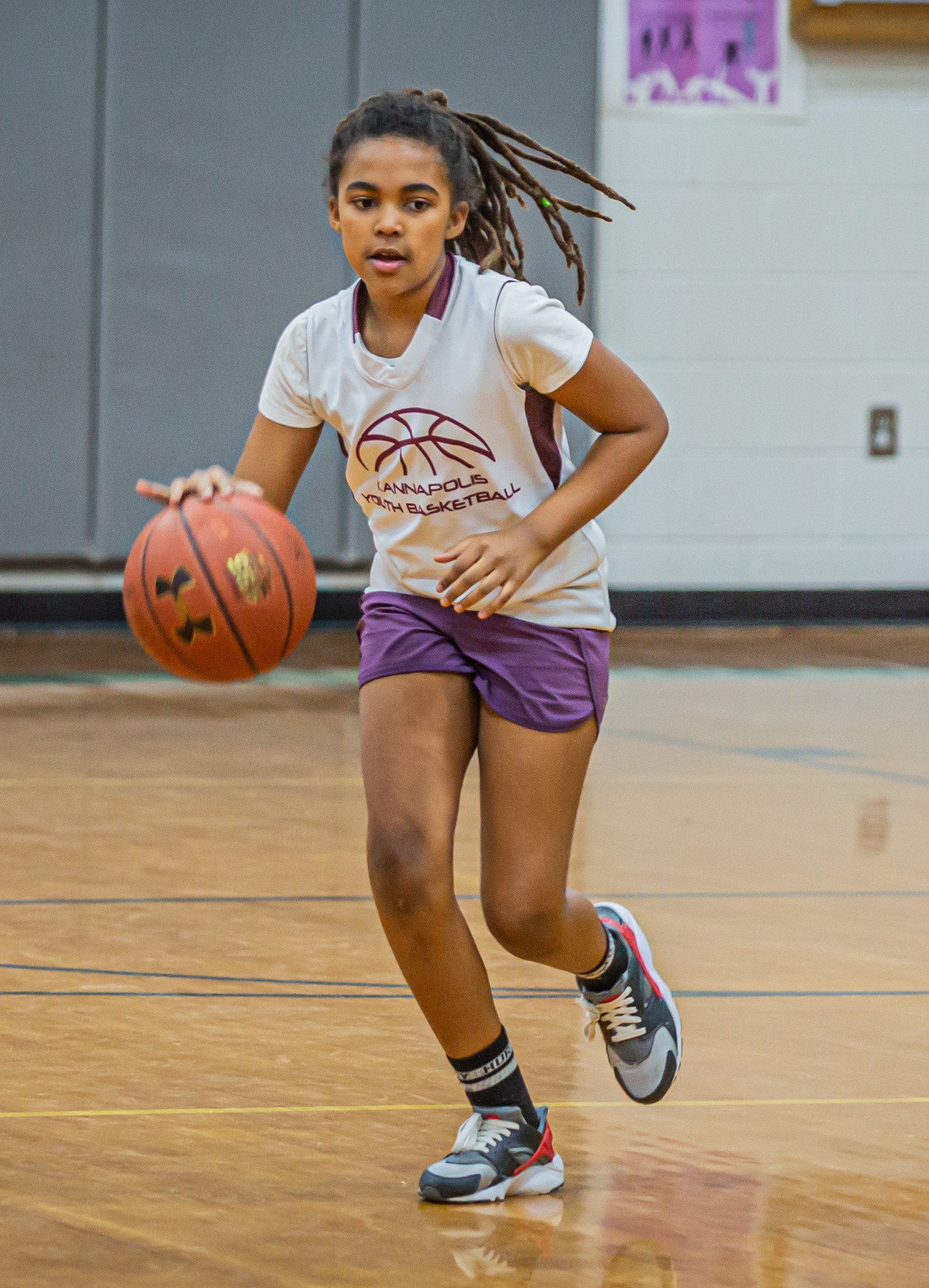 girl dribbling a basketball