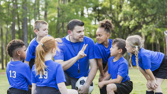 Soccer coach with players